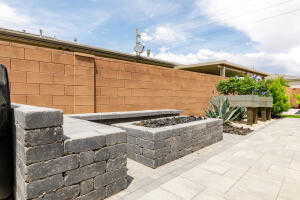 Fenced backyard with an outdoor fire pit and a patio