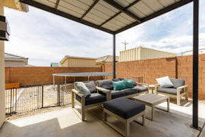 Fenced backyard with an outdoor living space and a patio