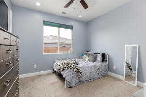 Carpeted bedroom featuring baseboards, a ceiling fan, and recessed lighting