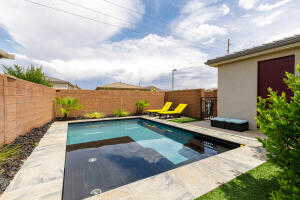 View of pool with a fenced backyard and a patio