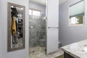 Bathroom featuring vanity and a stall shower