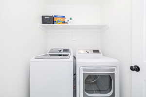 Laundry room with washer and clothes dryer