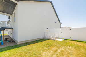 View of property exterior featuring a gate and stucco siding