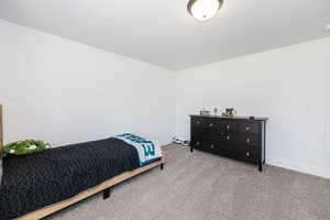 Bedroom featuring carpet and baseboards