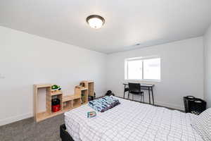 Bedroom featuring baseboards and carpet floors