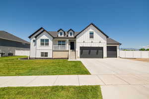 Modern farmhouse style home with board and batten siding, covered porch, concrete driveway, and central air condition unit