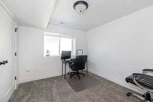 Carpeted office featuring baseboards