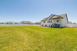 Back of house with a gate and stucco siding