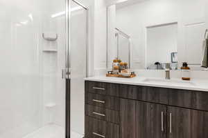 Full bath featuring a shower stall and vanity