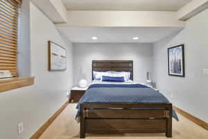 Carpeted bedroom with baseboards and recessed lighting