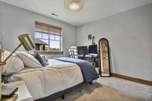 Carpeted bedroom with baseboards