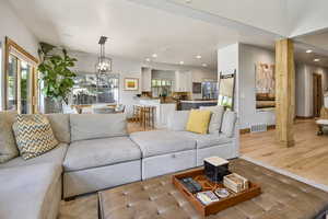 Living room featuring recessed lighting, a chandelier, baseboards, wood finished floors, and a textured ceiling