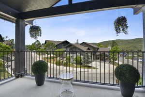 View of patio featuring a balcony and a mountain view