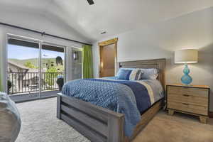 Carpeted bedroom featuring vaulted ceiling and access to outside