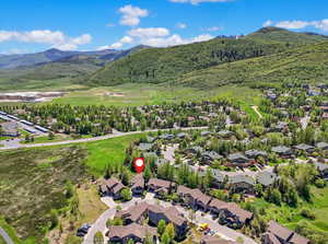 Aerial view of residential area featuring a mountainous background
