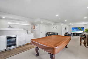 Game room featuring beverage cooler, and bar with sink