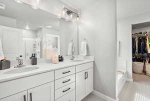 Owner's ensuite featuring a shower stall, and double vanity