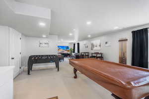 Recreation room with light colored carpet, and  recessed lighting