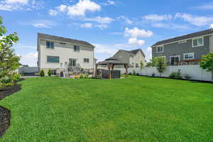 Rear view of property featuring a gazebo