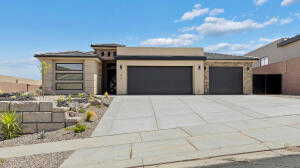 View of front of house with an attached garage and driveway