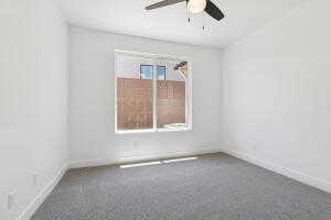 Empty room featuring a ceiling fan, carpet flooring, and baseboards