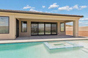 View of pool featuring an exterior structure, an outdoor structure, a patio, and a pool with connected hot tub