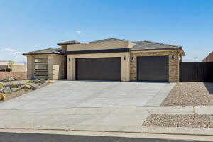 Prairie-style house featuring an attached garage and concrete driveway