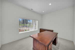 Home office featuring light colored carpet, recessed lighting, and baseboards