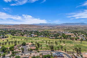 Aerial perspective of suburban area with mountains and a local golf course