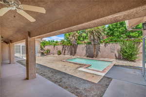 View of swimming pool with a fenced backyard, a ceiling fan, and a patio