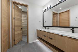 Bathroom featuring double vanity and tile patterned floors