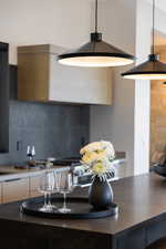 Kitchen featuring tasteful backsplash and dark countertops