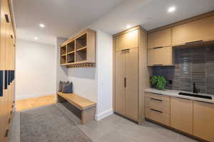 Mudroom with a sink, recessed lighting, and baseboards