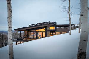 View of snow covered rear of property