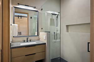 Bathroom with a stall shower and vanity