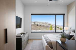 Bedroom with multiple windows, light wood-style flooring, recessed lighting, baseboards, and a ceiling fan