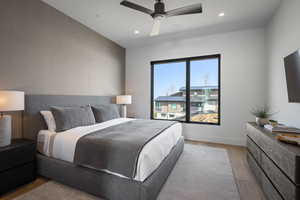 Bedroom featuring light wood finished floors, recessed lighting, a ceiling fan, and baseboards