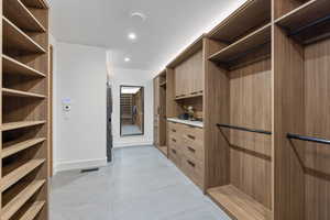 Spacious closet with light tile patterned floors