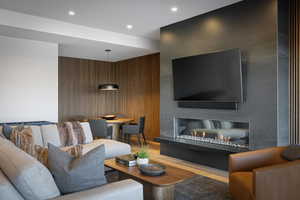 Living room with light wood-style flooring and recessed lighting