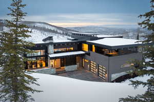 Contemporary house with a mountain view, a garage, and stone siding