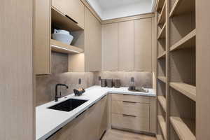 Kitchen with open shelves, modern cabinets, and a sink