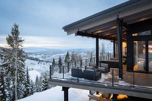 Snow covered deck with a mountain view
