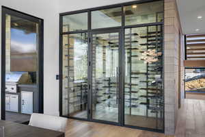 Wine cellar featuring wood finished floors