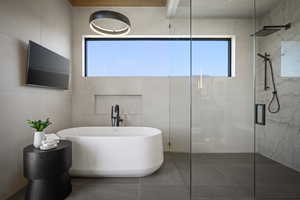 Bathroom with a soaking tub, a tile shower, tile walls, and tile patterned floors
