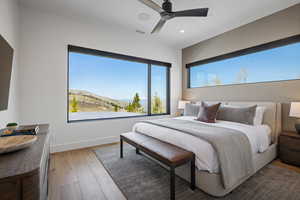 Bedroom with hardwood / wood-style flooring, baseboards, multiple windows, recessed lighting, and ceiling fan