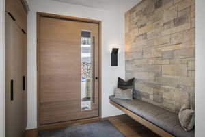 Foyer featuring a sauna / steam room, baseboards, and wood finished floors