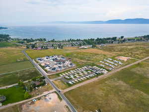 Aerial view of property and surrounding area featuring a water and mountain view