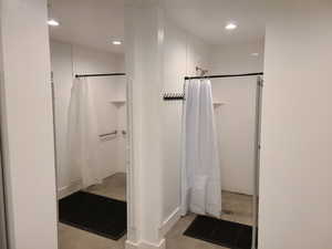 Full bathroom with a shower with shower curtain, recessed lighting, and concrete flooring