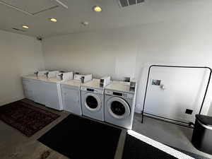 Shared laundry featuring washing machine and dryer, recessed lighting, and baseboards