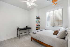 Bedroom with light colored carpet and ceiling fan